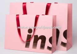 Luxury Custom Retail Matt Pink Uncoated Paper Shopping Bags With Gold Hot Stamp And Red Ribbon Handle